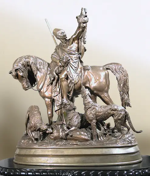 A man conquering on a horse while holding a lioness head