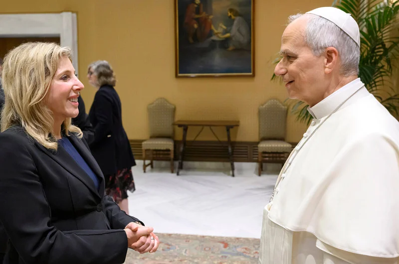 woman with blond hair in a black dress suit conversing with the Pope President Lori Meets Pope Leo XIV