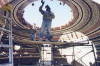 Two people work on constructing a stone dome. U.K. Architect Talk: Tangible Spirituality & Sustainable Architecture (Sept. 10)