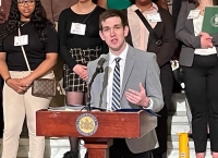 male student in grey suit talking at podium with other students behind him Preparing for Law School: How Marywood’s Pre-Law Programs Set You Up for Success