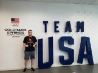 Nick Macano pictured next to a Team USA sign.