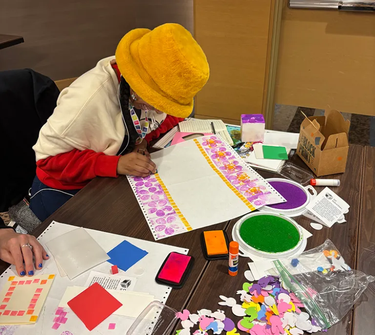 woman doing a craft of some sort at the conference