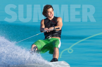 A young man is pictured on a wakeboard making a splash in the water with the word 