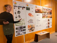 girl presenting work displayed on wall