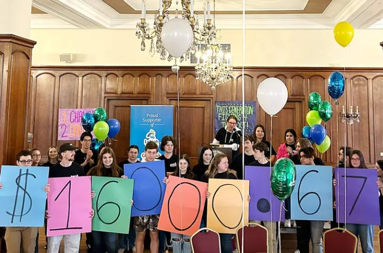 A group of students holds signs revealing the numbers of $16,000.67, the amount raised for Lehigh Valley Reilly Children's Hospital.