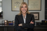 smiling blond woman in a black suit with her arms crossed President Lisa A. Lori Appointed to AICUP Board