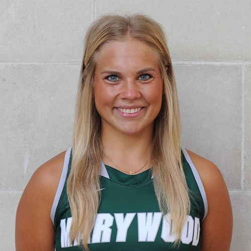 A blonde woman wearing a Marywood basketball jersey.