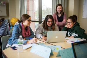 Four Marywood Female Education Students Looking at Laptop Marywood's Higher Education Program Earns Top Ranking