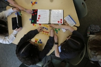 aerial view of students working with colored pieces on table Personalized Learning: Differentiated Instruction in Secondary K-12 Education