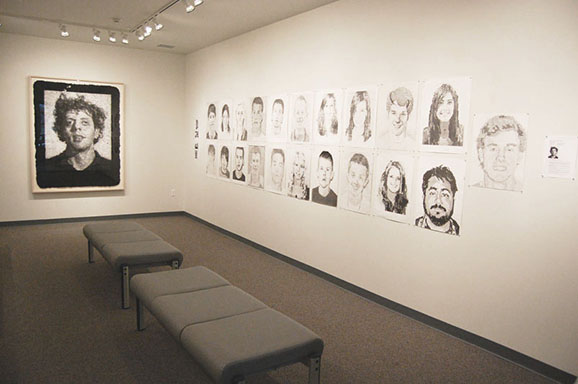 A room full of art exhibits including photographs