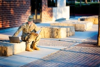 A student veteran sittimng on the curb. Three Financial Aid Tips for Veterans at Marywood