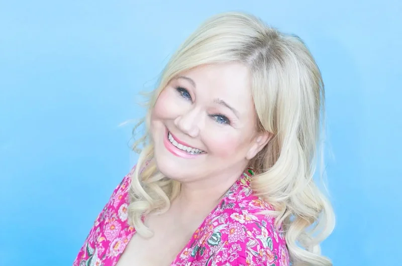A blonde woman in a pink print shirt agains a light blue background Actress/Comedian Caroline Rhea to Serve as Marywood University’s Commencement Speaker