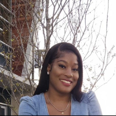 womans headshot with trees and building in background 