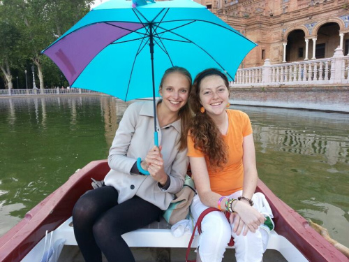 two female students in Spain under umbrella 